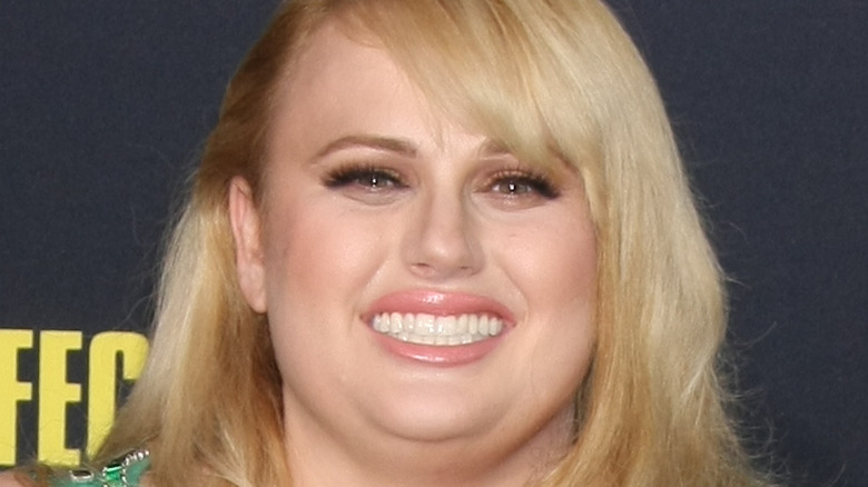 Rebel Wilson smiling on the red carpet