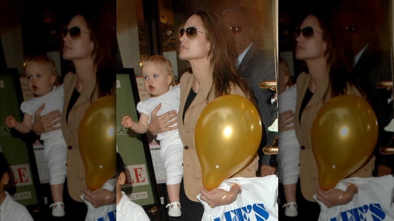 Angelina Jolie holding Shiloh Jolie-Pitt