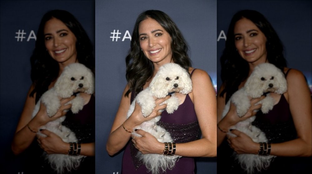 Lauren Silverman smiling while holding her dog
