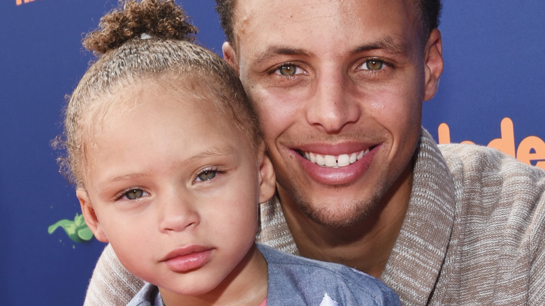 Riley Curry and Steph Curry at an event