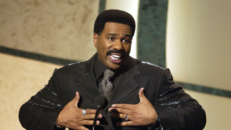 Steve Harvey speaking animatedly onstage 