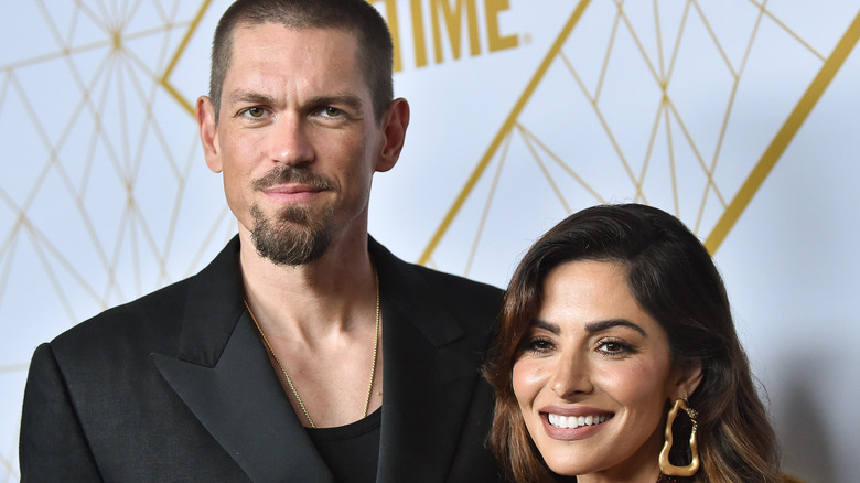 Steve Howey and Sarah Shahi posing together