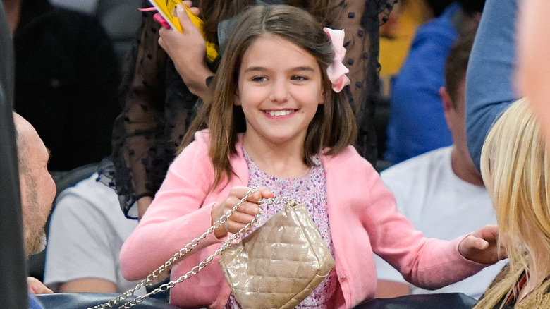 Suri Cruise holding purse