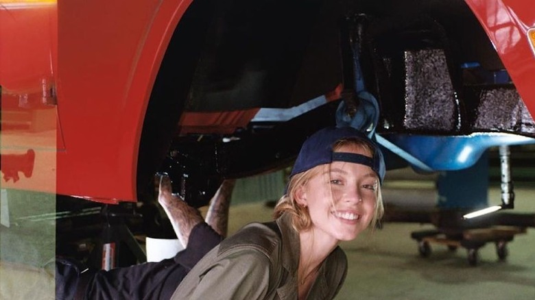 Sydney Sweeney working on a car