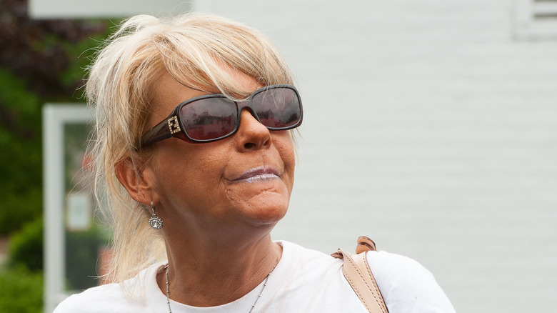 Patricia Krentcil walking in sunglasses and white tee