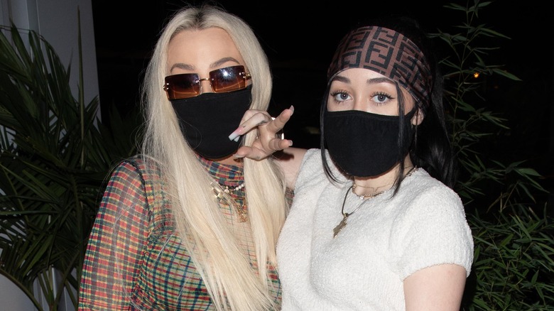 Tana Mongeau and Noah Cyrus posing with masks on