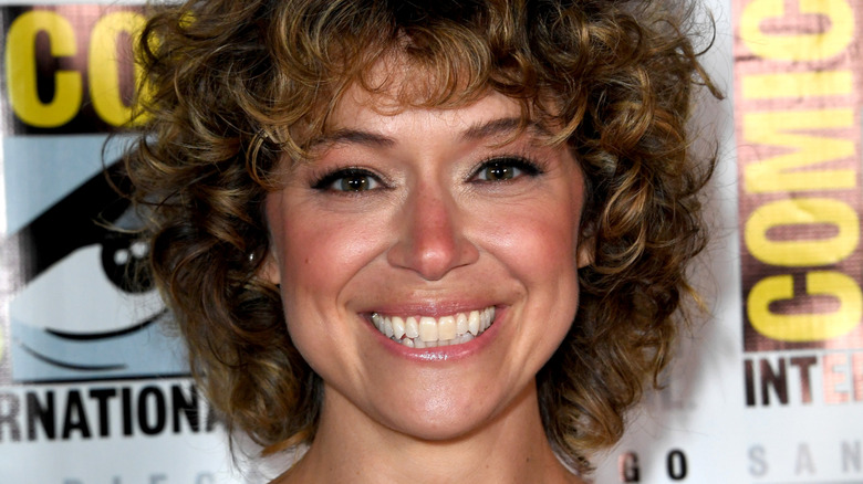 Tatiana Maslany smiling with curly hair