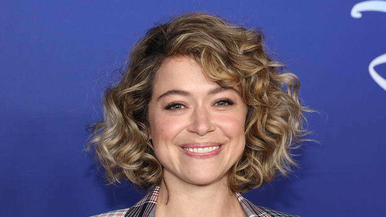 Tatiana Maslany smiling with blonde curls
