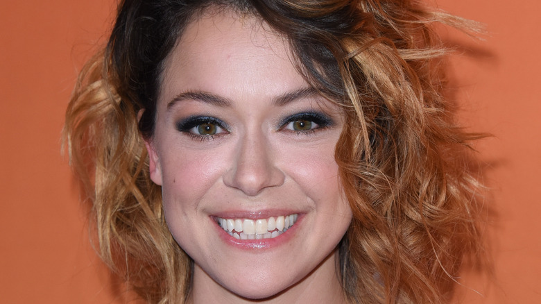 Tatiana Maslany smiling with messy hair
