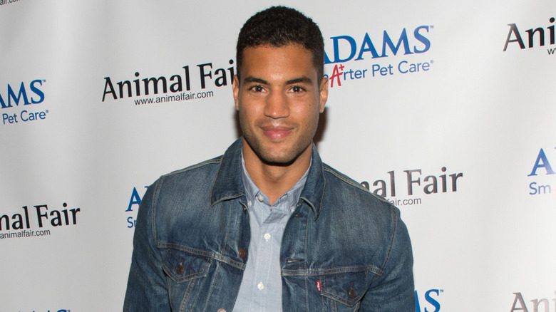 Devin Goda wearing a denim jacket at a fashion show fundraiser
