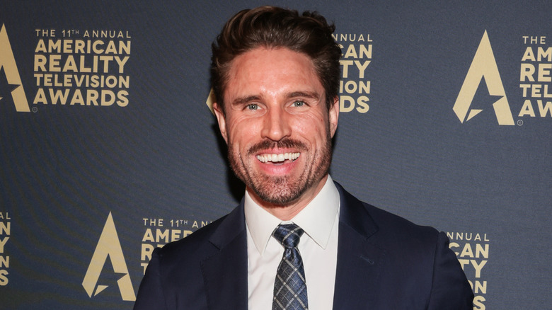 James O'Halloran wearing a blue plaid tie at the 2024 Annual Reality TV Awards