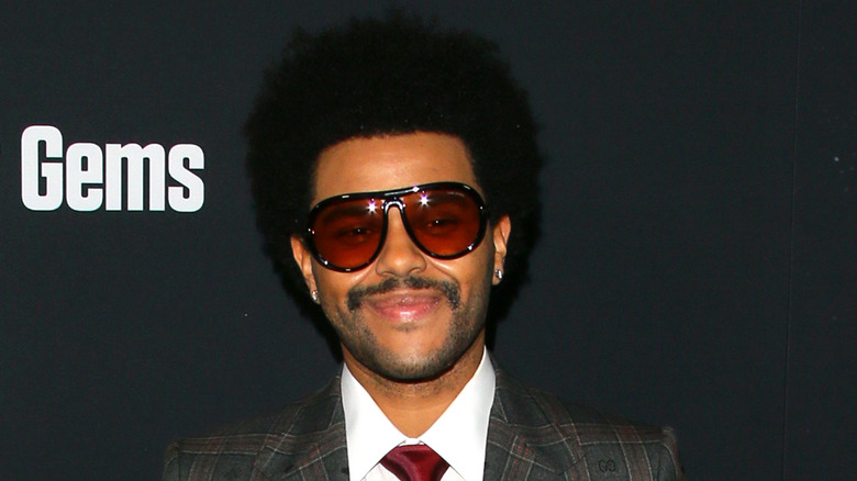 The Weeknd smiling red aviators
