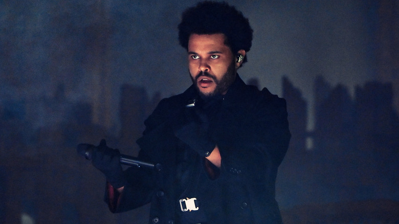 The Weeknd gesturing wearing gloves