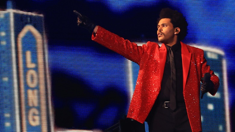 The Weeknd pointing to right