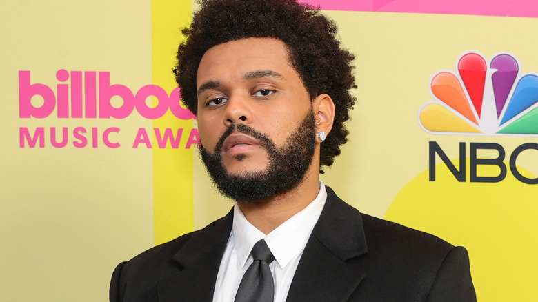 The Weeknd pouting in earrings