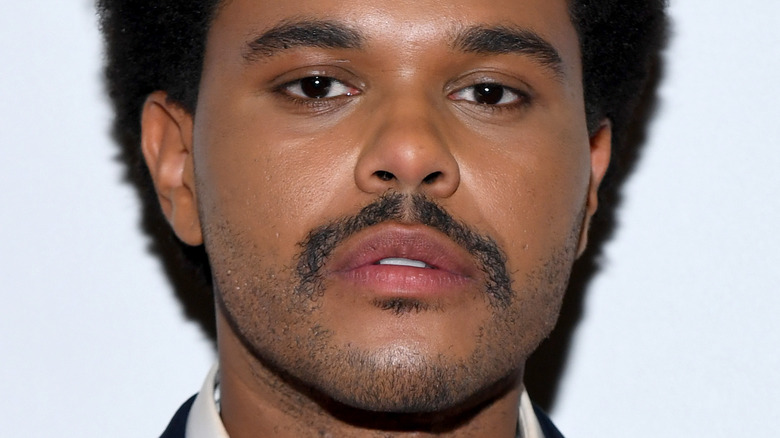 The Weeknd posing relaxed mustache