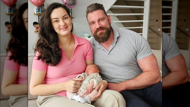 Olivier sitting with girlfriend and baby