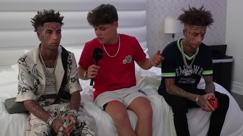The Island Boys sitting on a bed with Jack Doherty