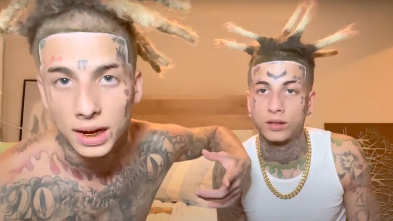 Island Boys sitting on a bed