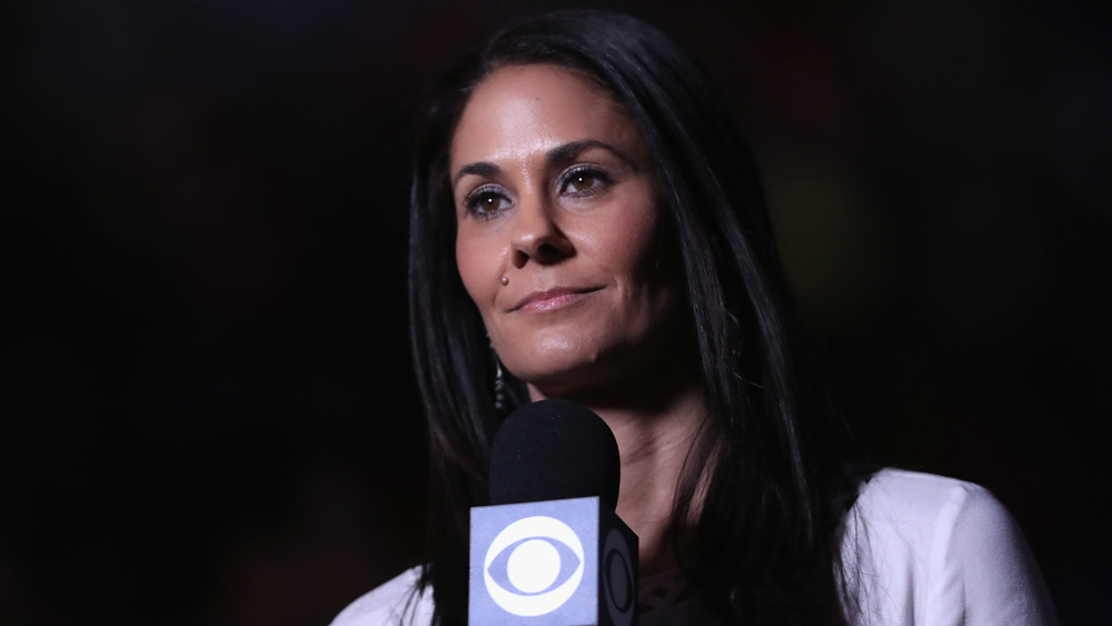 Tracy Wolfson holds a microphone