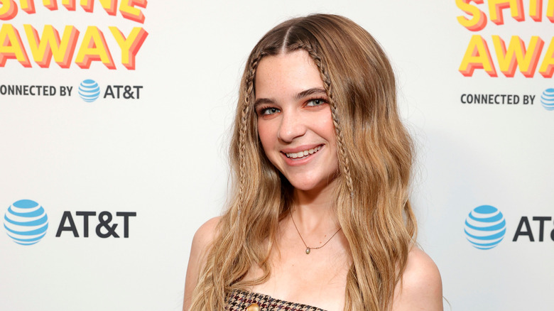 Raegan Revord posing on the red carpet at a Hello Sunshine event