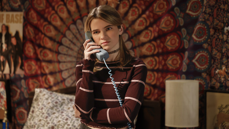 Raegan Revord as Missy Cooper talking on a telephone