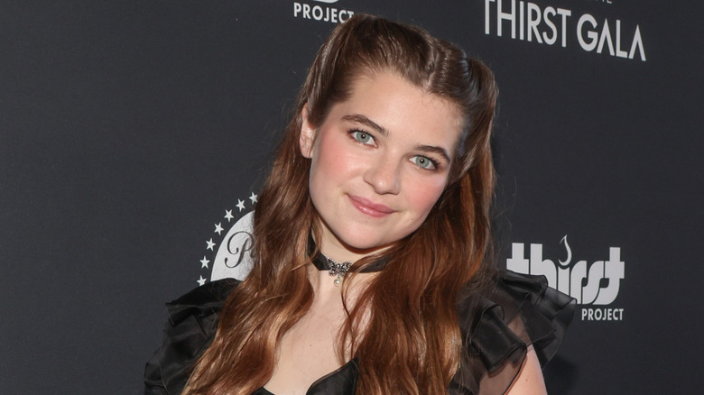 Raegan Revord posing in front of a dark background at Thirst Gala