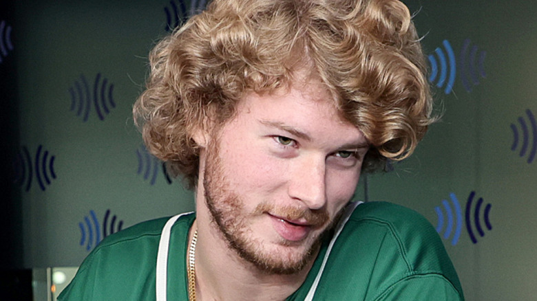 Yung Gravy in green shirt and curly hair