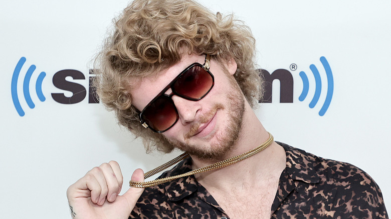 Yung Gravy holding chain and smiling
