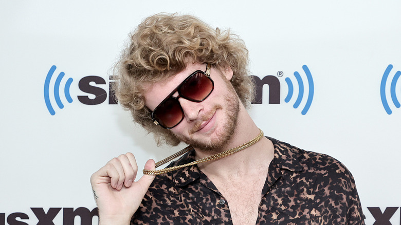 Yung Gravy holding chain and smiling