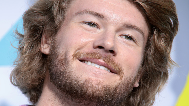 Yung Gravy in pink shirt and dark jacket