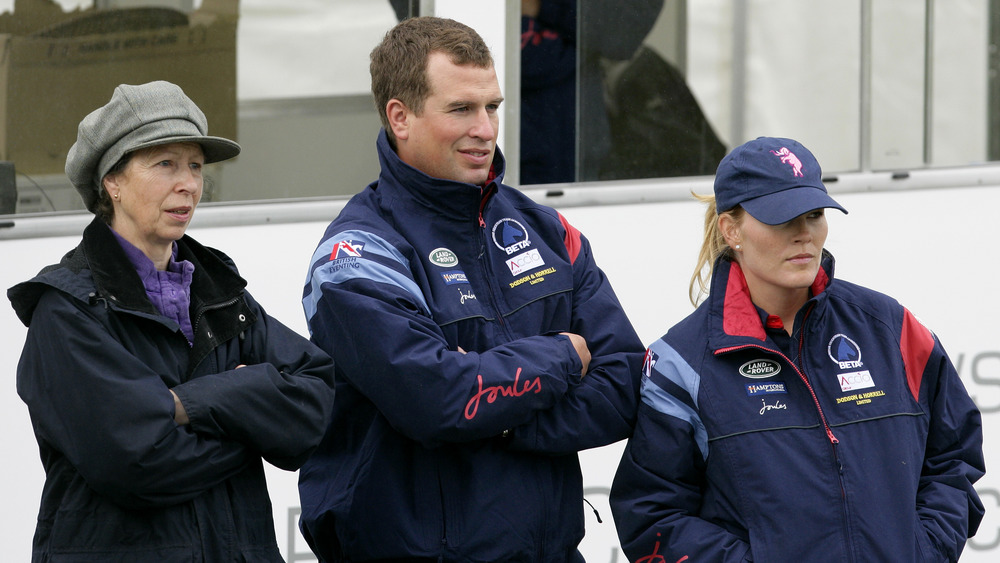Princess Anne, Peter Phillips, and Autumn Phillips standing together