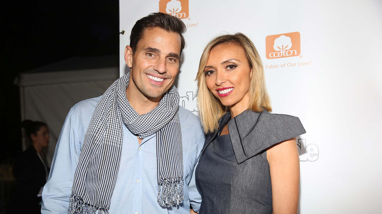 Bill Rancic and Giuliana Rancic wear warm, cheerful smiles.