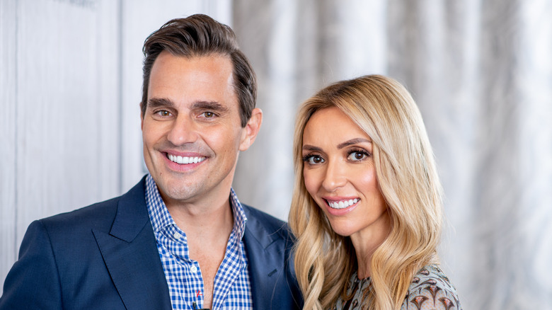 Bill Rancic and Giuliana Rancic flash bright smiles.
