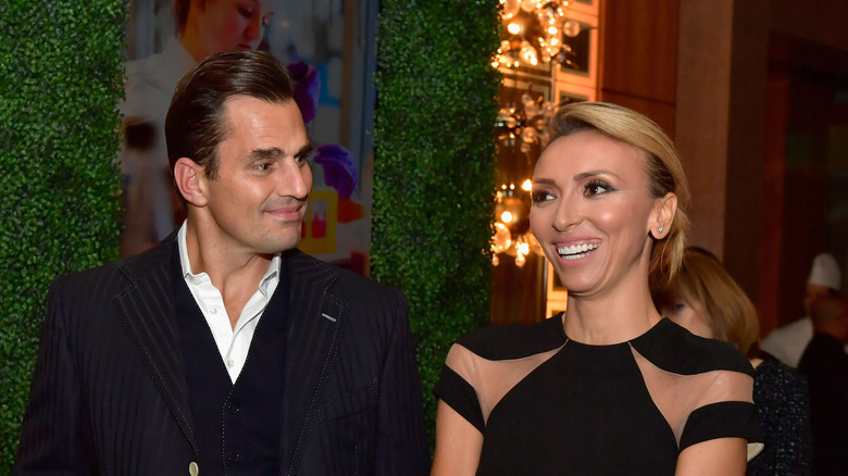 Bill Rancic gazes at the brightly smiling Giuliana Rancic.