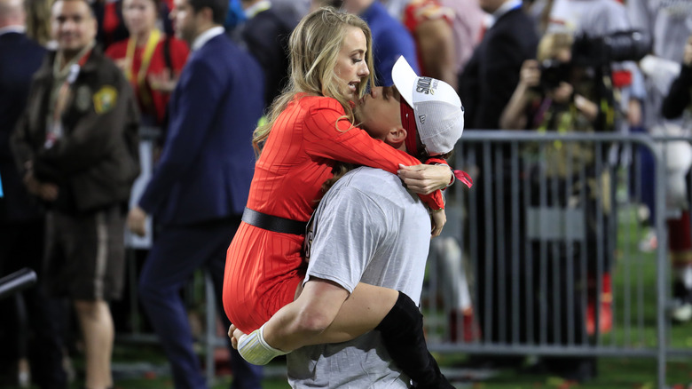 Patrick holds Brittany Mahomes up at the 2020 Super Bowl.