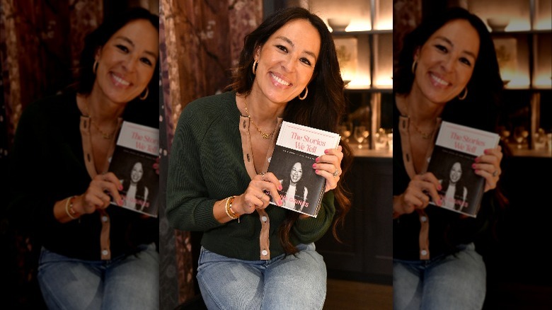Joanna Gaines smiles holding her book
