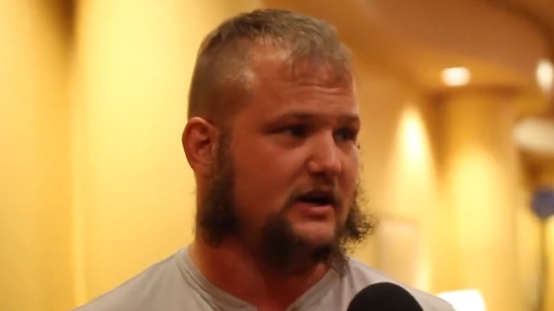 Jody Kristofferson speaks into a microphone.