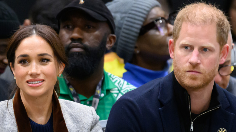 Meghan Markle sitting next to Prince Harry