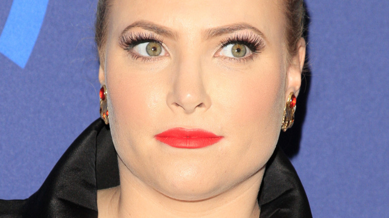 Meghan McCain with red lipstick and serious expression 