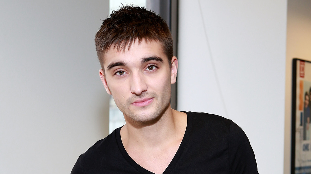 Tom Parker smirking