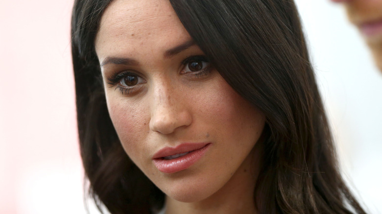 Meghan Markle with somber expression