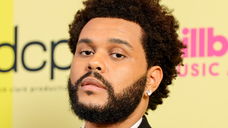 The Weeknd poses backstage for the 2021 Billboard Music Awards