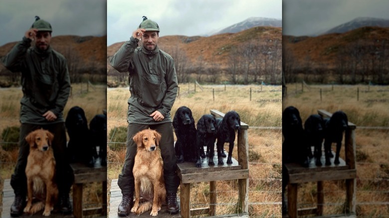James Middleton poses with his dogs outdoors