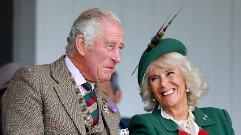 Charles and Camilla laughing together.