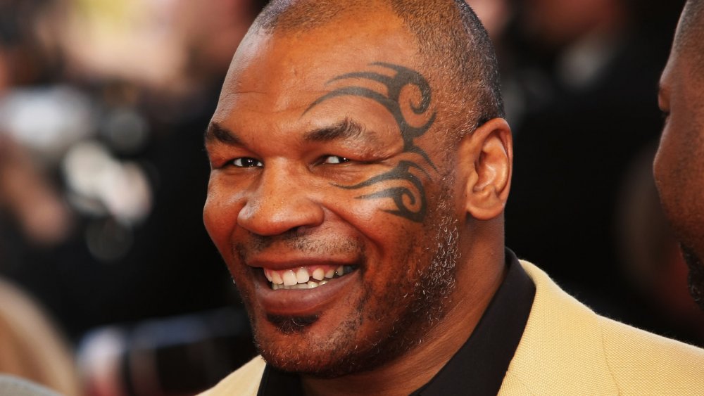 Mike Tyson with face tattoo, grinning