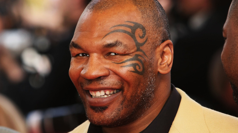 Mike Tyson with face tattoo, grinning