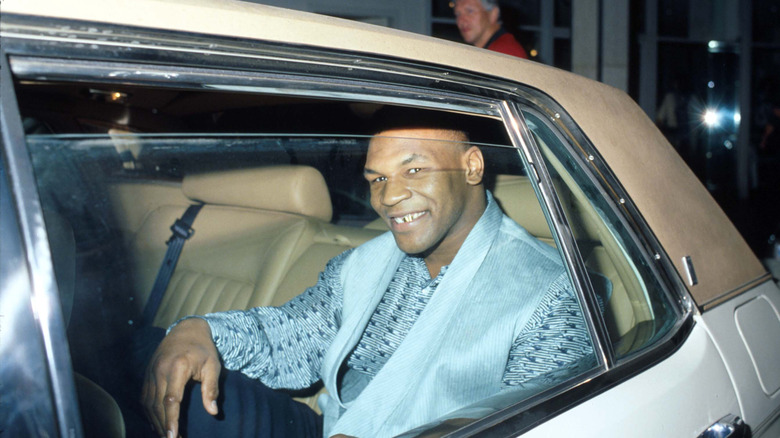Mike Tyson smiling in a car