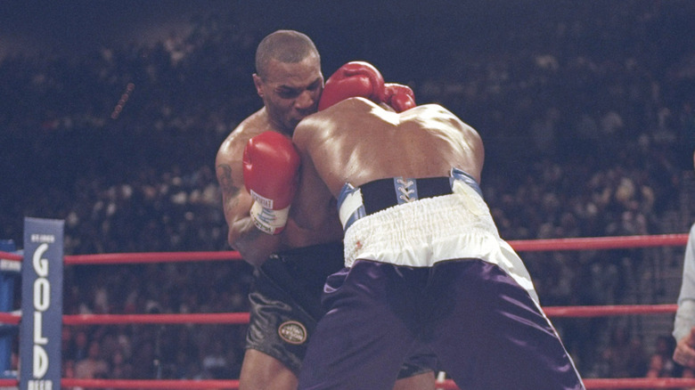 Mike Tyson biting Evander Holyfield's ear off