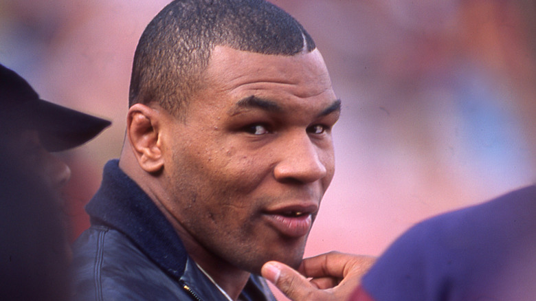 Mike Tyson, looking back at camera in a crowd